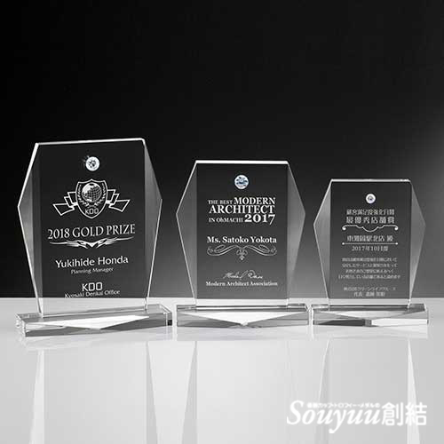 ジルコニア表彰楯・優勝楯クリスタルアワードAKS-1605 黄金比の楯に流氷の天使のようなカットを付加。どっしりとした安定感があるのに、動きも感じられるデザインです。ジルコニアダイヤモンドの直径はA.Bは15mm、Cは10mmです。Aサイズ高さ209.2mm横幅170mm奥行70mm　重量：約2.04g 21000円、Bサイズは高さ184.9mm横幅150mm奥行65mm　重量：約1.490g 18750円、Cサイズは高さ160.6mm横幅130mm奥行60mm　重量：約1.020g 16500円です。